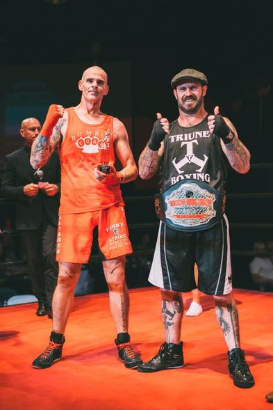 Bretto after the boxing title fight, holding the Triune Boxing belt